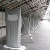 The curator's favourite installation. Handmade "sacks" stretching from floor to ceiling. Underneath is a pool of dust, as though they haven't been used for years. I thought this piece by Hilary Bower captured the disused mill environment, and was a perfect and moving fit for the empty Spinning Room