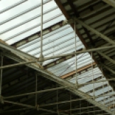 The mill's ancient weather vane seen through the glass roof
